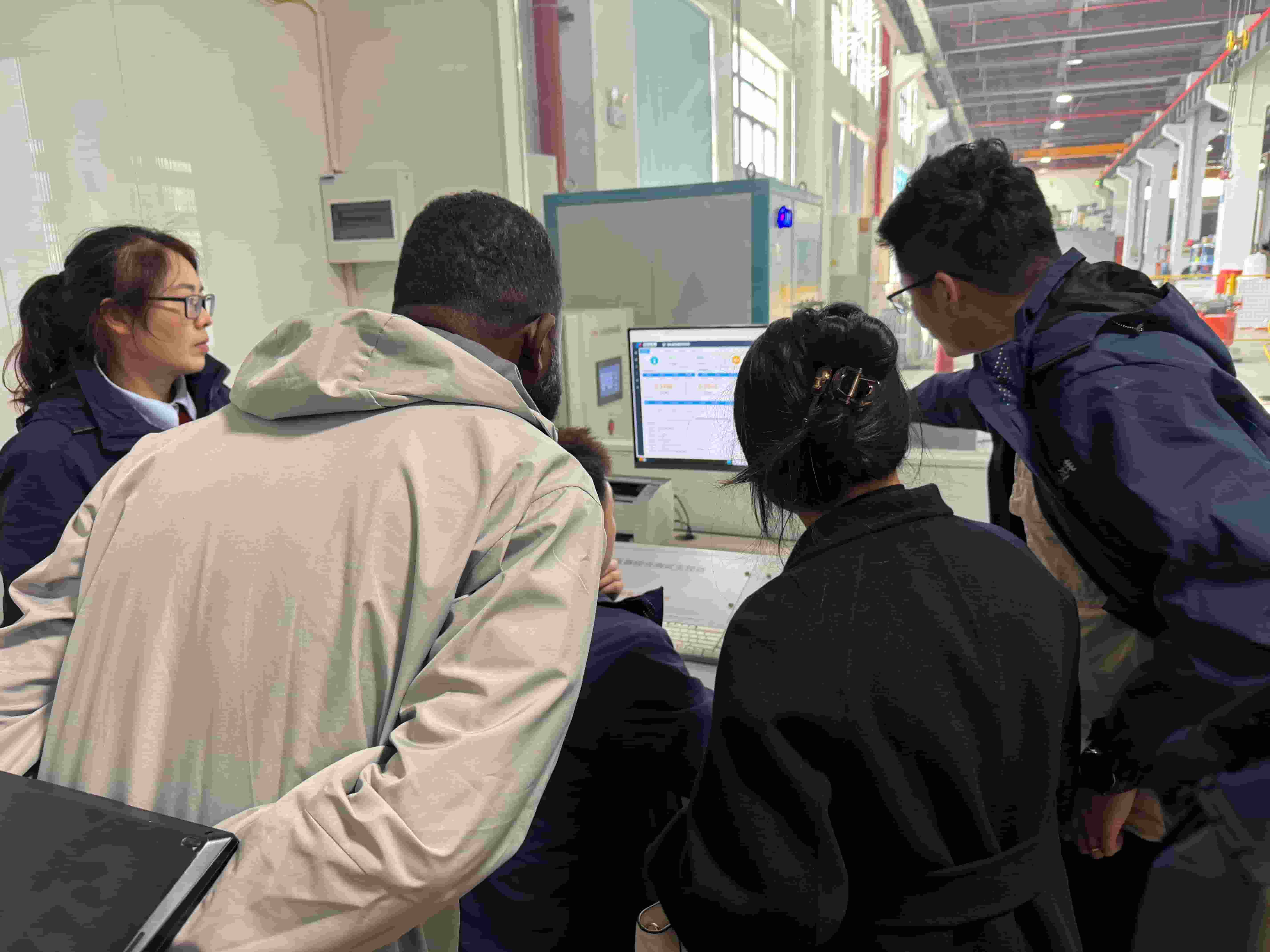 Tanzanian clients visit the quality testing room of Beyondt's transformer factory.